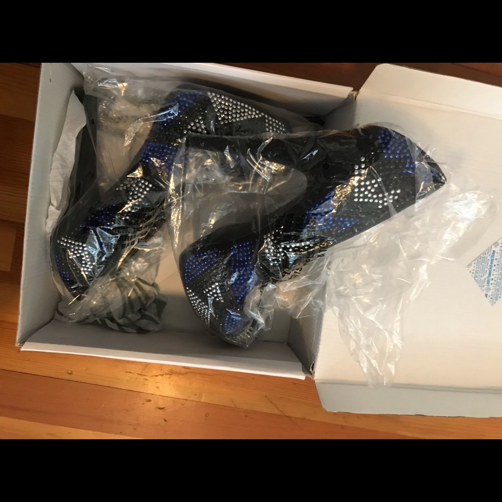 Black, silver, and blue pumps. Brand new. Size 10.